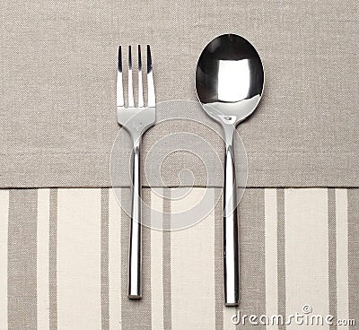 Fork and spoon on canvas napkin Stock Photo