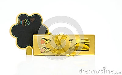 Fork and spoon in gold box cutlery with ornaments and blackboard card on white background Stock Photo