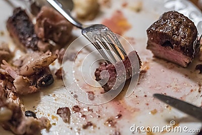 Fork stabbing a piece of meat Stock Photo