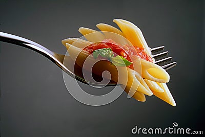 Fork with tomato pasta and basil Stock Photo