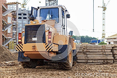 A forklift at a construction site is lifting a reinforced concrete slab. Construction machine. Industry Stock Photo