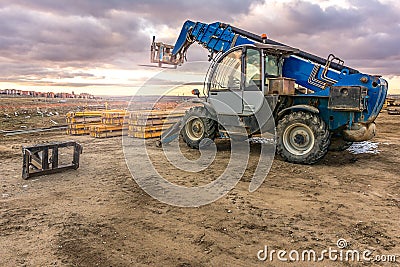 Forklift on a construction site, preparing to raise construction parts Stock Photo