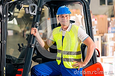 Forklift driver at warehouse of forwarding Stock Photo