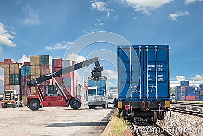 Forklift handling container box loading to freight train Stock Photo