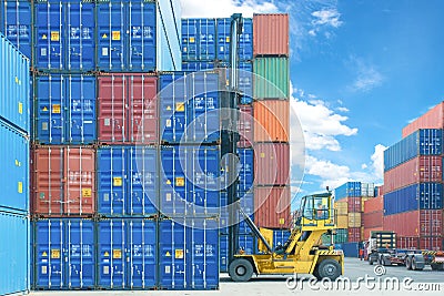 Forklift handling container box loading to truck in import export logistic zone. Stock Photo