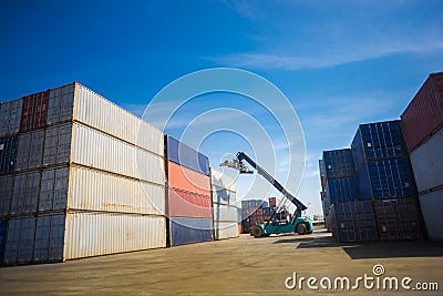 Forklift handling container box loading to truck in logistic zone Stock Photo