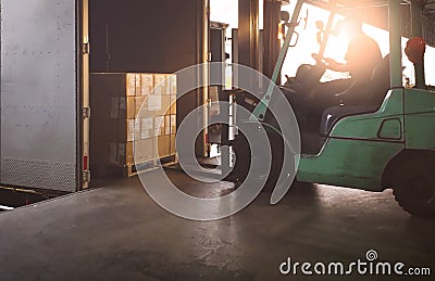 Forklift Tractor Loading Package Boxes into Cargo Container at Dock Warehouse. Delivery Service. Shipping Warehouse Logistics. Stock Photo