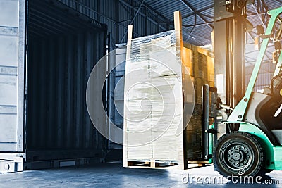 Forklift Tractor Loading Package Boxes into Container Truck. Warehouse Shipping. Freight Truck Transport Logistic Stock Photo
