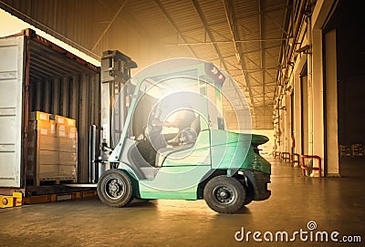 Forklift Tractor Loading Package Boxes into Container Truck. Shipment Supplies Warehouse. Freight Truck Transport Logistics Stock Photo