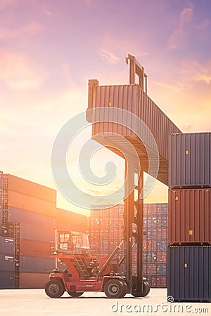 Forklift truck lifting cargo container in shipping yard Stock Photo