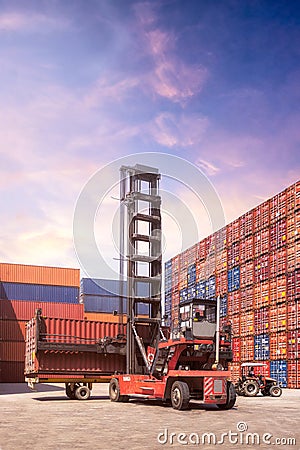 Forklift truck lifting cargo container in shipping yard Stock Photo