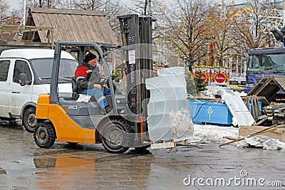 A forklift worker makes transportation of ice blocks to storage sites Editorial Stock Photo