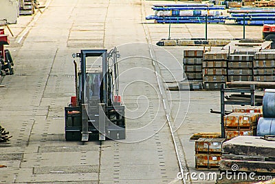 Forklift works in an open warehouse in the seaport. Stock Photo