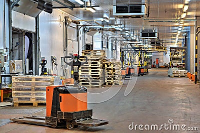 Forklifts pallet truck in loading dock inside cold storage wa Editorial Stock Photo