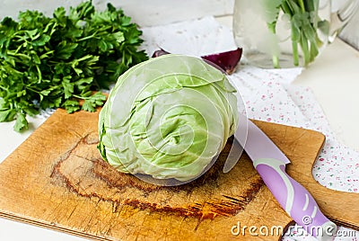 Forks young cabbage on a cutting board and knife Stock Photo