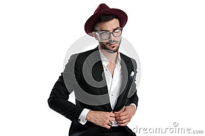 Formal business man sitting and fixing jacket while dreaming Stock Photo