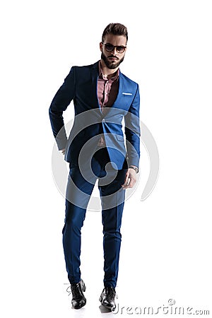 Formal businessman in blue suit standing on tips confident Stock Photo