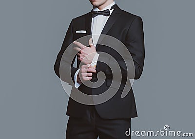 Formal classic suit. Business style outfit. Retro suit fashion. Handsome businessman adjusting his sleeves. Stock Photo