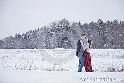 Formal couple outdoors in winter snow Stock Photo