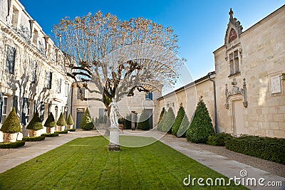 Garden of Chateau Haut Brion, Bordeaux France. Beautiful formal garden, courtyard with statue on lawn Stock Photo