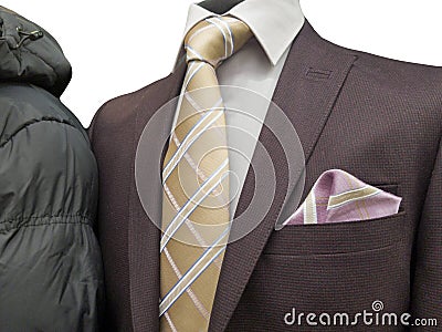 Formal suit and an common winter coat on an exhibition isolated on white. Stock Photo