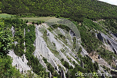 Formation of earth pyramids in mountain landscape, french Hautes-Alpes Stock Photo