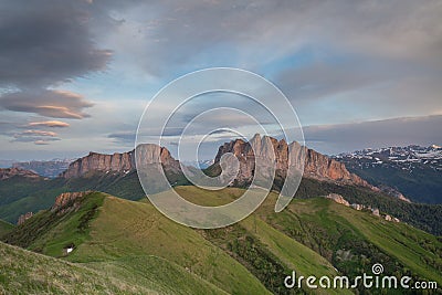 The formation and movements of clouds up to the steep slopes of the mountains of Central Caucasus peaks. Stock Photo