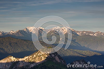 The formation and movements of clouds up to the steep slopes of the mountains of Central Caucasus peaks. Stock Photo