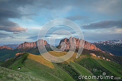 The formation and movements of clouds up to the steep slopes of the mountains of Central Caucasus peaks. Stock Photo