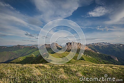 The formation and movements of clouds up to the steep slopes of the mountains of Central Caucasus peaks. Stock Photo