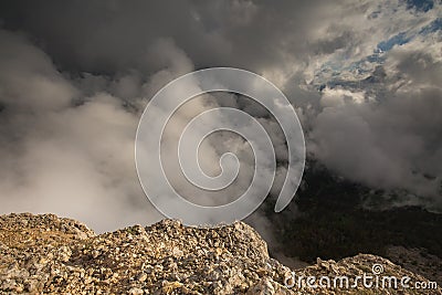 The formation and movements of clouds up to the steep slopes of the mountains of Central Caucasus peaks. Stock Photo