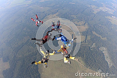 Formation skydiving. A group of skydivers are doing a sequential in the sky. Stock Photo