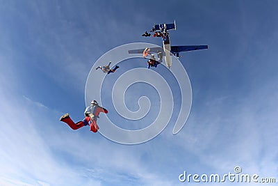 Formation skydiving. Skydivers are jumping out of a plane. Editorial Stock Photo