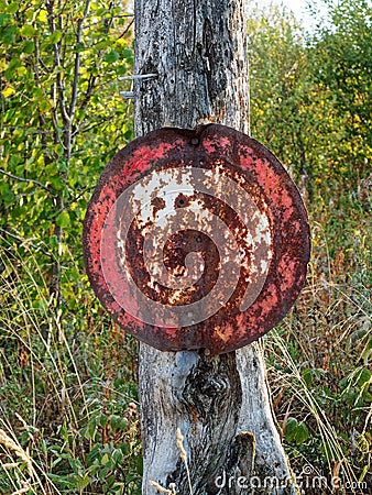 Old rusted prohibition sign on tree in German forest Stock Photo