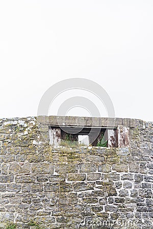WWII defended building that is former windmill. Copyspace above. Stock Photo