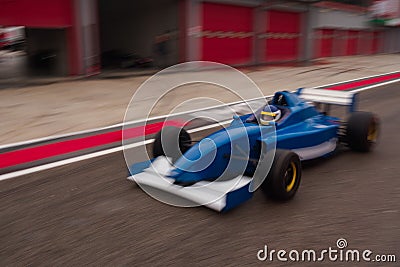 Formula car is approaching the track from the pitlane Stock Photo
