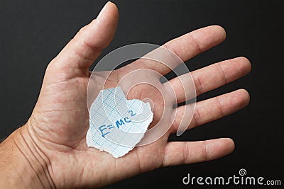 The formula E = mc2 in the hand Stock Photo