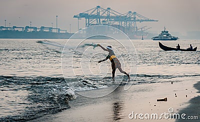 Fort Kochi fisherman throwing his net into Editorial Stock Photo