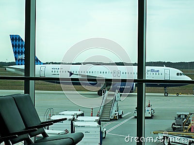 Fort Myers,FLA,USA,May 7,2019. Jet Blue plane coming into terminal.view from window while waiting to board plane. Editorial Stock Photo