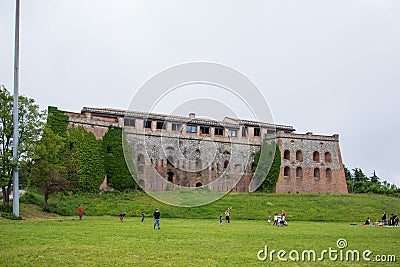 Forte Begato with people playing football in front of it Editorial Stock Photo