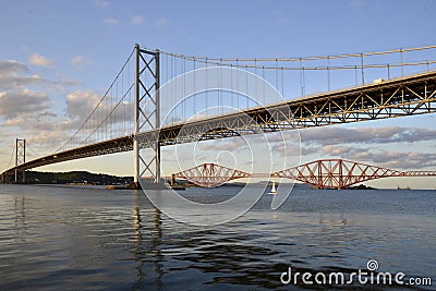 Forth Road Bridge with the Forth Bridge in the background at dusk. Stock Photo