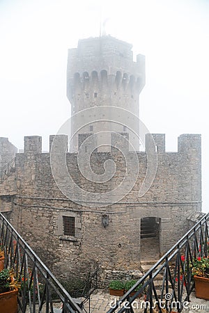 Fortification on top of the mountain covered by the cloud, old castle. Journey. Mystical atmosphere, fog, white haze, mist. Summer Stock Photo