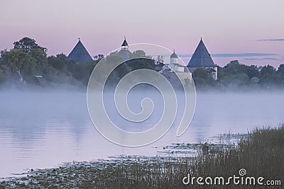Fortress in the city of Staraya Ladoga on the Volkhov River with a foggy pink summer dawn Stock Photo