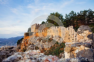 Fortress wall of the Alanya castle in the Old Town. Crenelated walls Alanya Kalesi. Selective focus Stock Photo