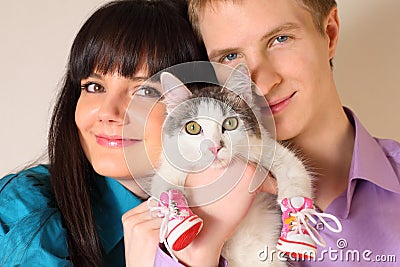 Fortunate young husband and wife hold cat Stock Photo