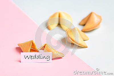 fortune cookie on pink and blue background, pastel colors, wedding prediction Stock Photo