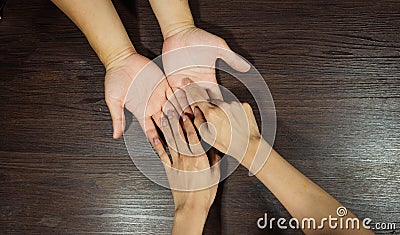 The fortune teller is looking at the palm. Or hand lines that indicate fate or predict fate By putting his hand on the brown Stock Photo