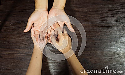 The fortune teller is looking at the palm. Or hand lines that indicate fate or predict fate By putting his hand on the brown Stock Photo