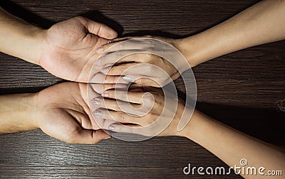 The fortune teller is looking at the palm. Or hand lines that indicate fate or predict fate By putting his hand on the brown Stock Photo