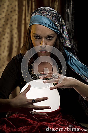 Fortune teller psychic gypsy at crystal ball Stock Photo